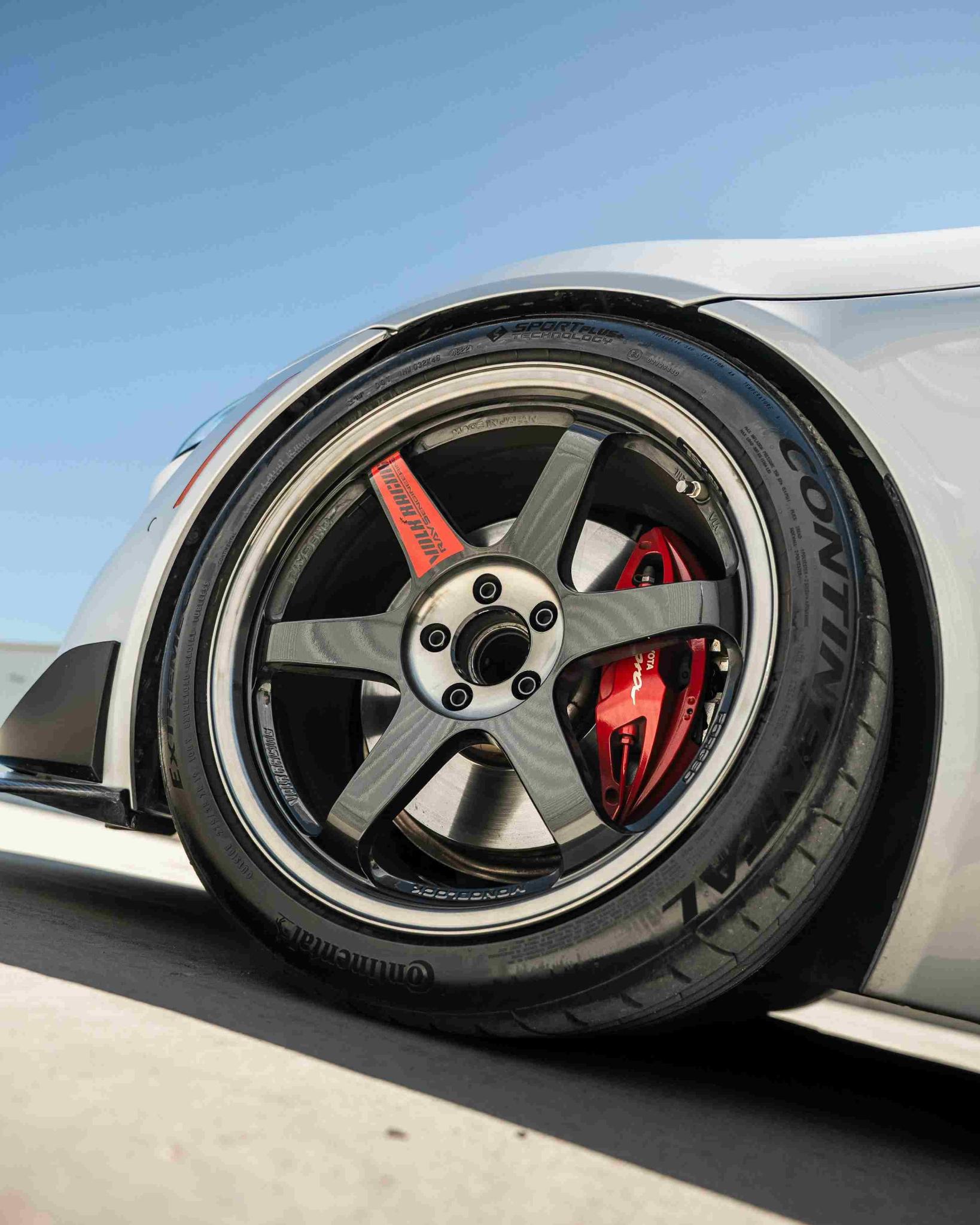 The wheel of a gray sports car.