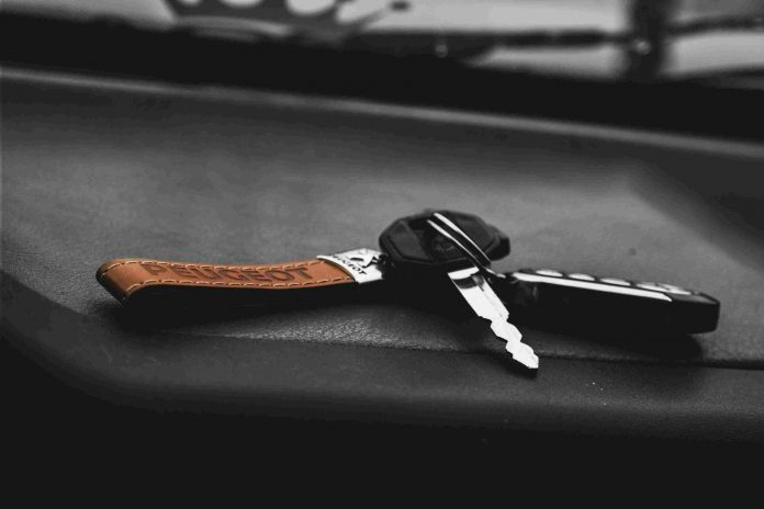 Car keys set on the dashboard of a vehicle.